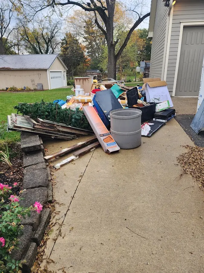 Dumpster being loaded with debris for 12 Yard Dumpster Rental in Dinuba
